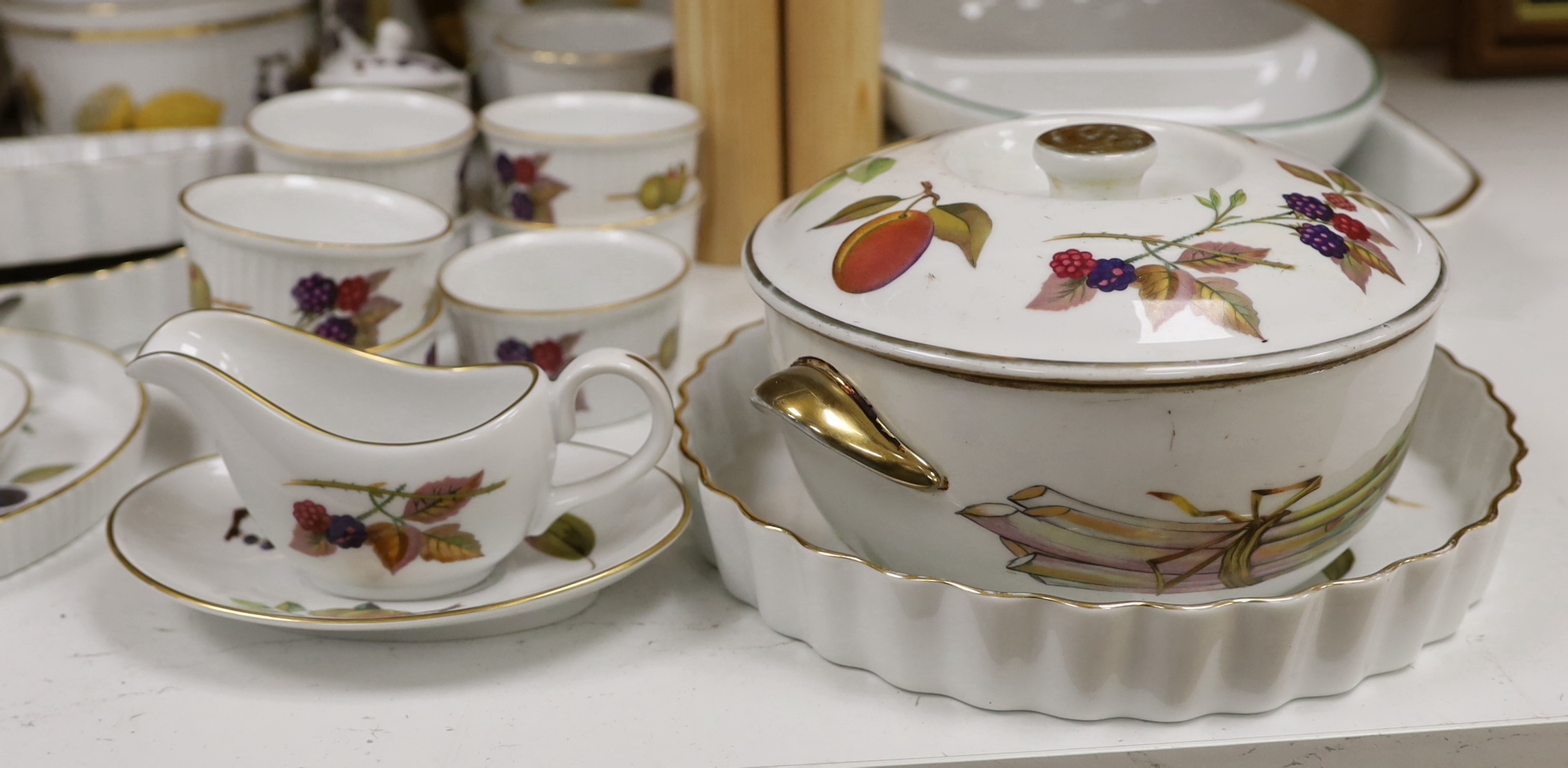 A Royal Worcester Evesham part dinner service, together with Portmeirion items including eight mugs, three lidded tureens, etc.